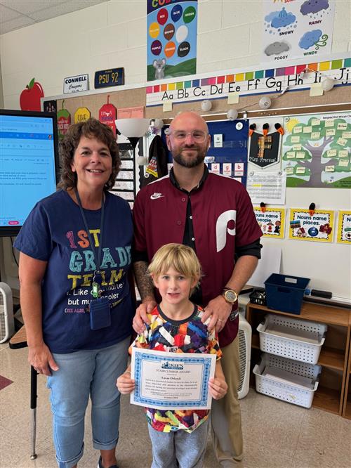 Lucas Orlandi, October Stairclimber recipient. poses with his certificate and school staff.